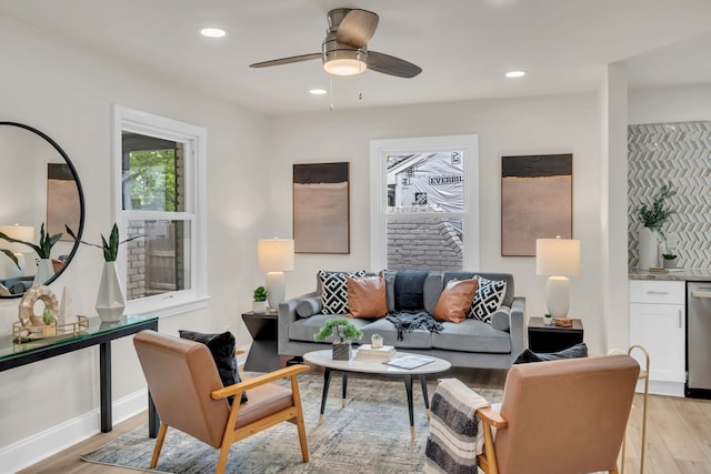 living room featuring ceiling fan and light wood-type flooring