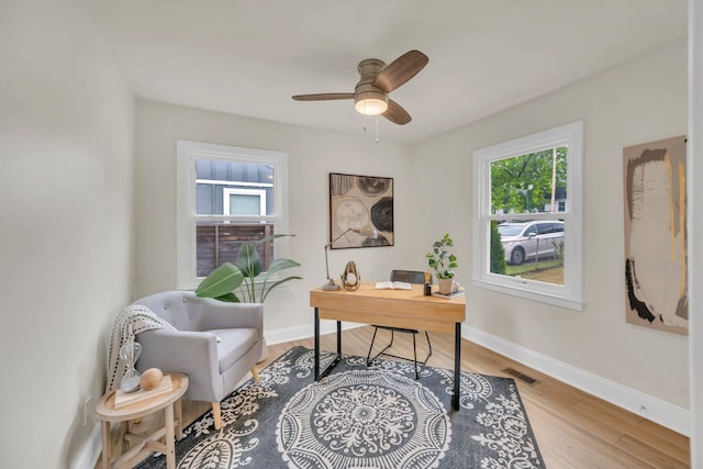 office area with ceiling fan and hardwood / wood-style floors