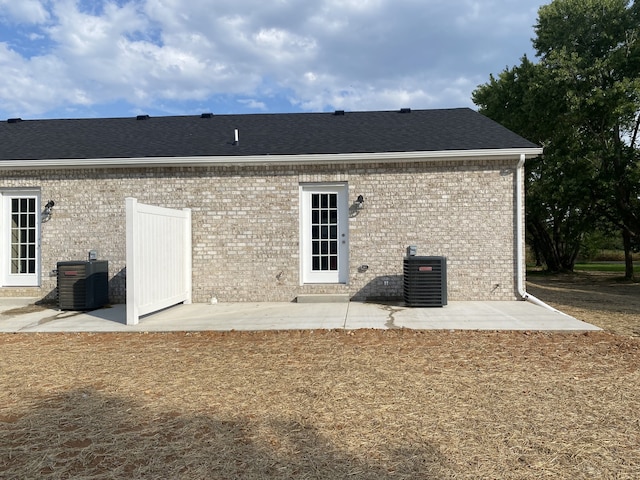 rear view of house with a patio and central air condition unit