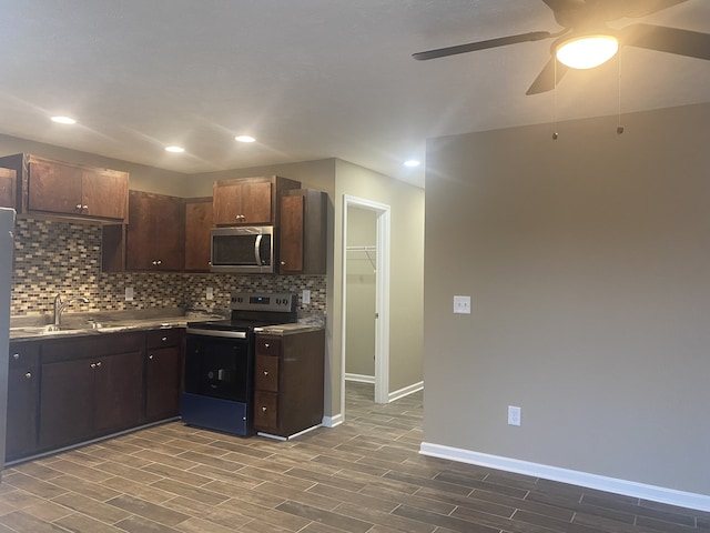 kitchen with ceiling fan, appliances with stainless steel finishes, dark hardwood / wood-style flooring, and dark brown cabinetry