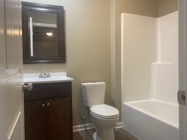 full bathroom featuring wood-type flooring, vanity, toilet, and  shower combination