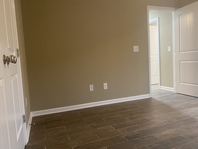 spare room with dark wood-type flooring