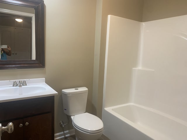 full bathroom with  shower combination, vanity, and toilet