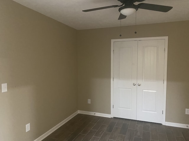 empty room featuring ceiling fan and dark wood-type flooring