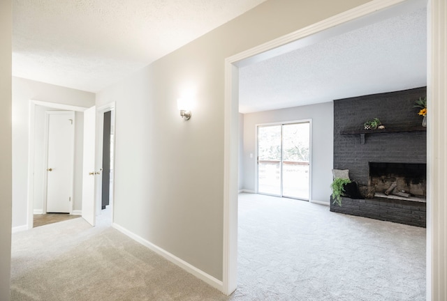 hall featuring a textured ceiling and carpet flooring