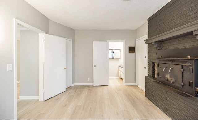 interior space featuring a textured ceiling and light hardwood / wood-style floors