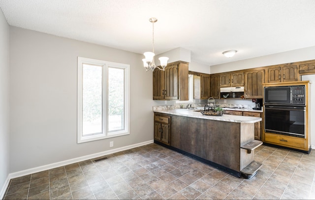 kitchen featuring sink, kitchen peninsula, an inviting chandelier, black appliances, and decorative light fixtures