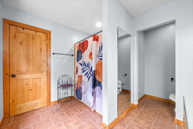 bathroom with tile patterned flooring, toilet, and a shower with shower curtain