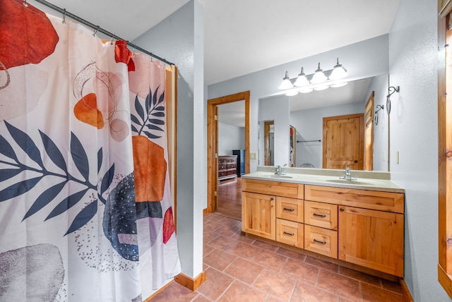 bathroom featuring walk in shower, vanity, and tile patterned floors