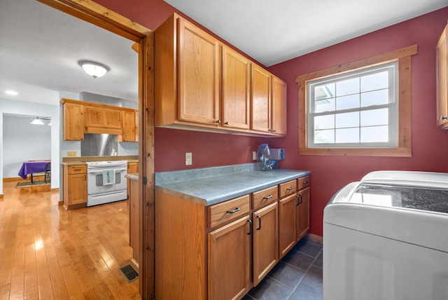 clothes washing area with washer and dryer and hardwood / wood-style floors