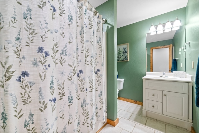 bathroom with a shower with shower curtain, vanity, toilet, and tile patterned floors