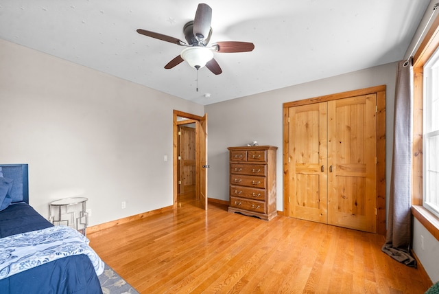 bedroom featuring a closet, light wood-type flooring, and ceiling fan