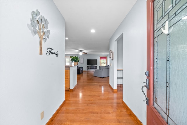 corridor with light hardwood / wood-style floors