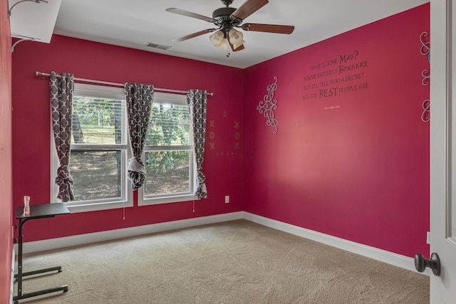 spare room featuring ceiling fan and carpet