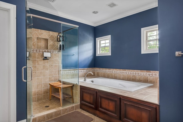 bathroom with ornamental molding and separate shower and tub