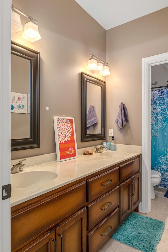 bathroom with tile patterned flooring, vanity, and toilet