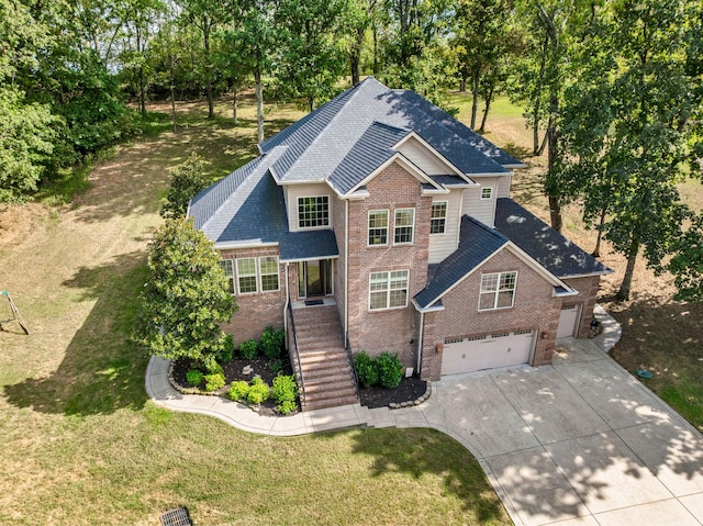 view of front of property featuring a garage and a front yard