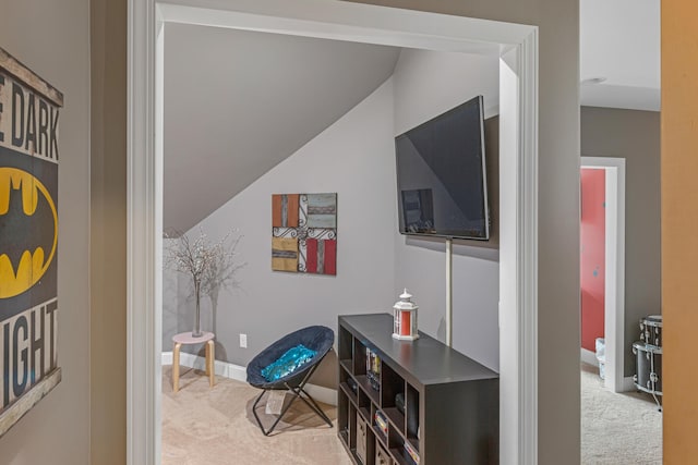 interior space with light carpet and vaulted ceiling