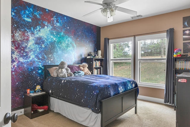 bedroom with ceiling fan and light carpet