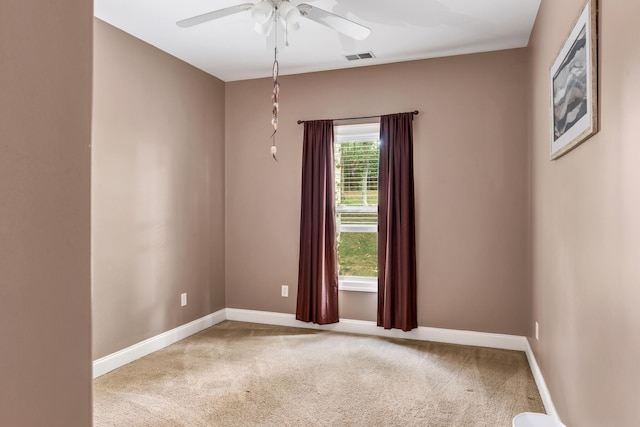 carpeted spare room with ceiling fan