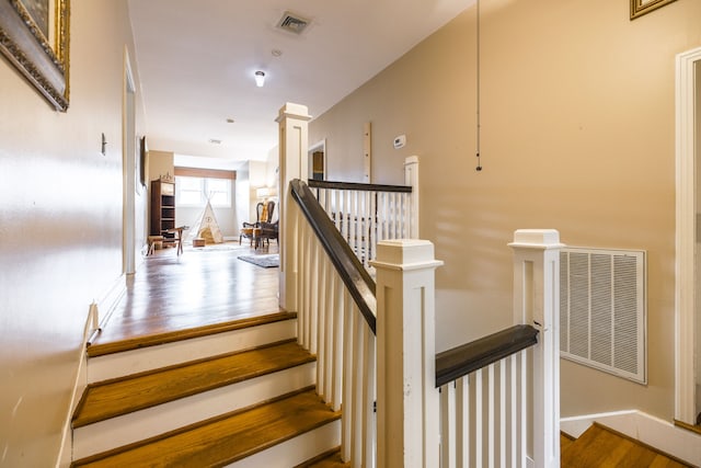 stairs with hardwood / wood-style floors