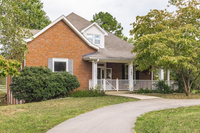 view of front of house featuring a front yard and covered porch