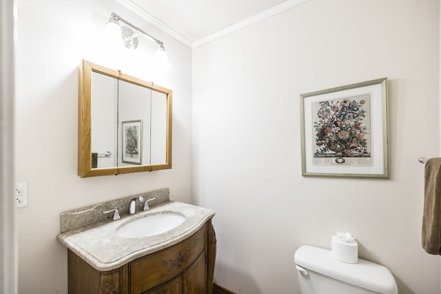 bathroom with ornamental molding, vanity, and toilet