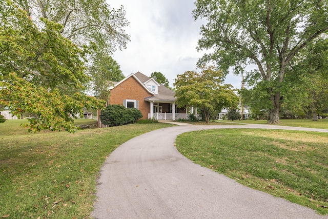 view of front facade with a front lawn and a porch