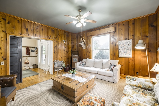 living room featuring ceiling fan, crown molding, light hardwood / wood-style floors, and a healthy amount of sunlight