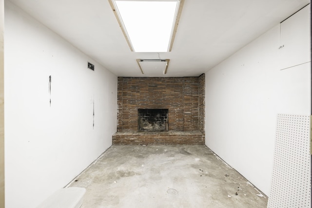 unfurnished living room featuring a brick fireplace