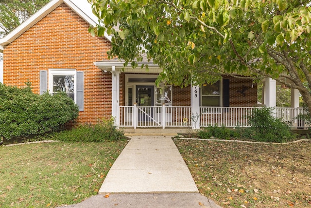 view of front of house with a front lawn and a porch