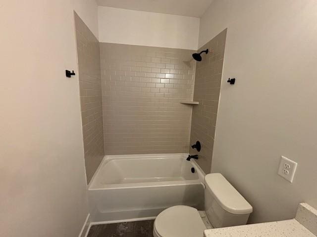 bathroom with shower / bathing tub combination, baseboards, and toilet