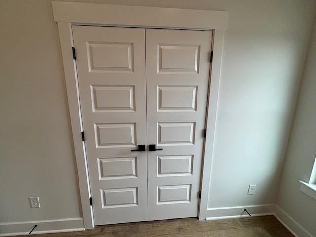 room details featuring baseboards and wood finished floors