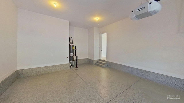 garage featuring water heater, baseboards, and a garage door opener