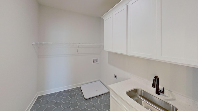 laundry room with a sink, electric dryer hookup, cabinet space, baseboards, and washer hookup