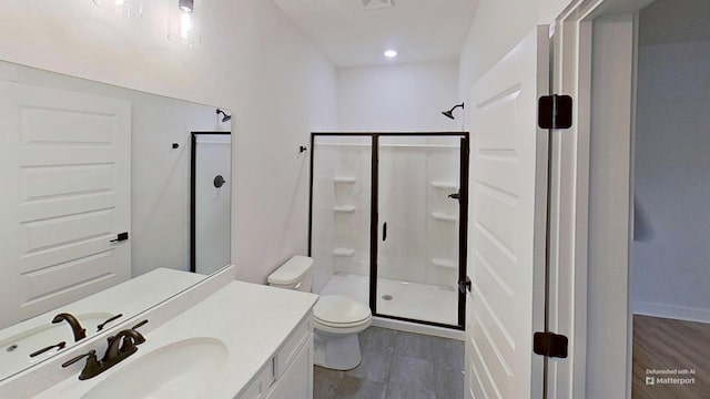 657 Gustaf Dr, Whites Creek, TN 37189 - bathroom with toilet, a stall shower, vanity, recessed lighting, and wood finished floors