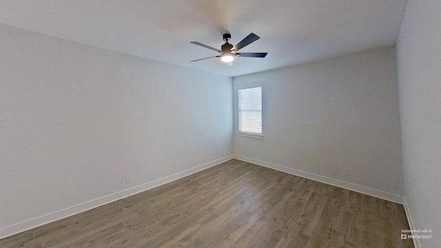 spare room with wood finished floors, baseboards, and ceiling fan