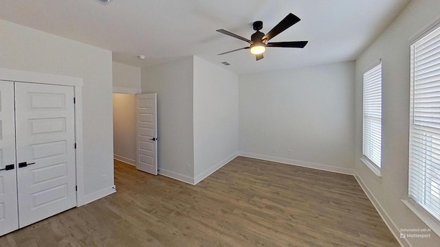 657 Gustaf Dr, Whites Creek, TN 37189 - unfurnished bedroom with light wood-style flooring, multiple windows, baseboards, and a ceiling fan