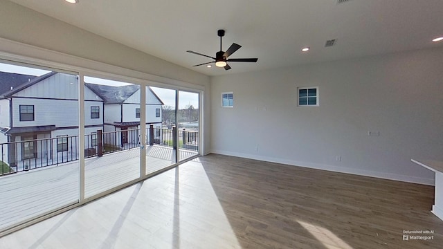 empty room featuring a ceiling fan, wood finished floors, baseboards, visible vents, and recessed lighting