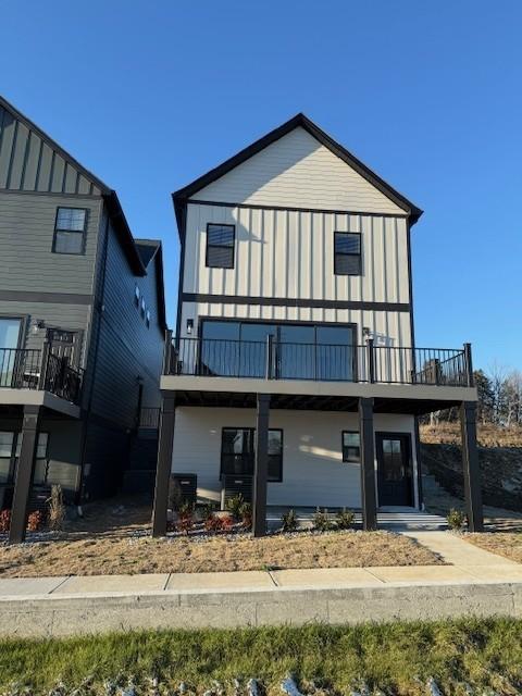 exterior space with board and batten siding and a balcony