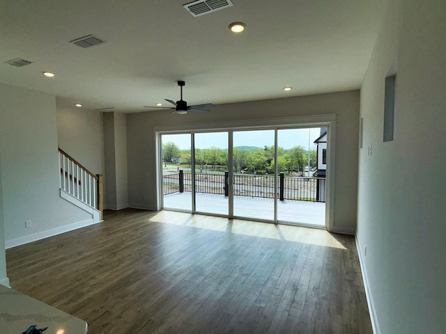 unfurnished living room with ceiling fan, baseboards, wood finished floors, and visible vents