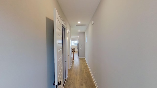 hallway featuring recessed lighting, baseboards, light wood-style floors, and visible vents