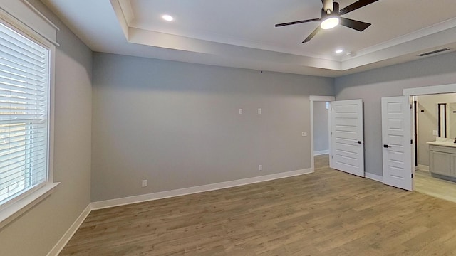 661 Gustaf Dr, Whites Creek, TN 37189 - unfurnished bedroom featuring a raised ceiling, light wood-style floors, recessed lighting, baseboards, and connected bathroom