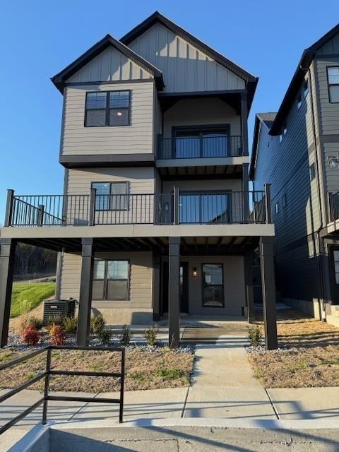 view of front facade featuring a balcony and board and batten siding