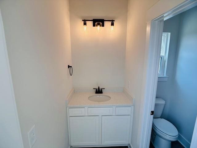 bathroom with toilet and vanity