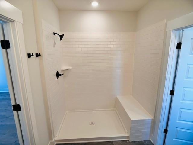 bathroom with a tile shower