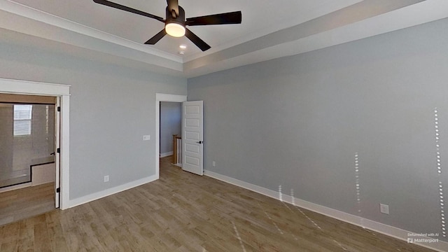 unfurnished bedroom featuring baseboards, wood finished floors, and recessed lighting