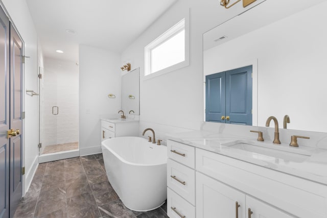 bathroom with vanity and independent shower and bath