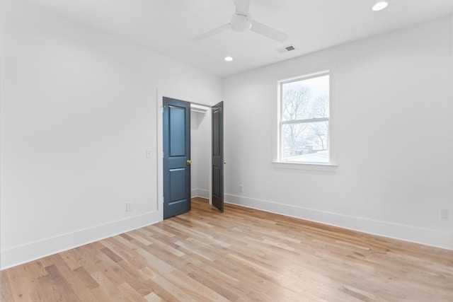 unfurnished bedroom with ceiling fan and light hardwood / wood-style floors