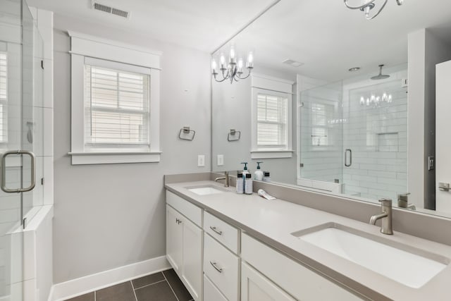 bathroom featuring walk in shower, vanity, tile patterned floors, and a healthy amount of sunlight